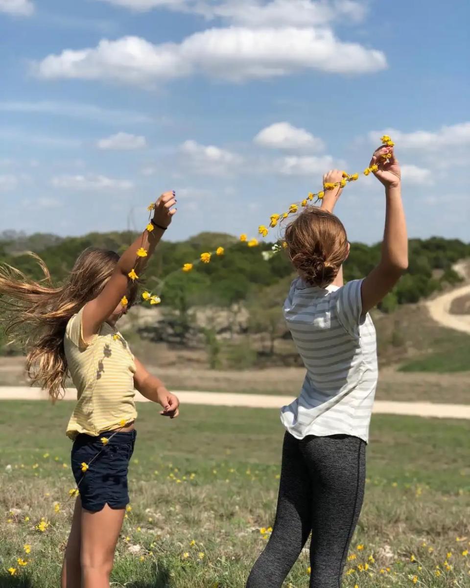 gaines family children in field with flowers