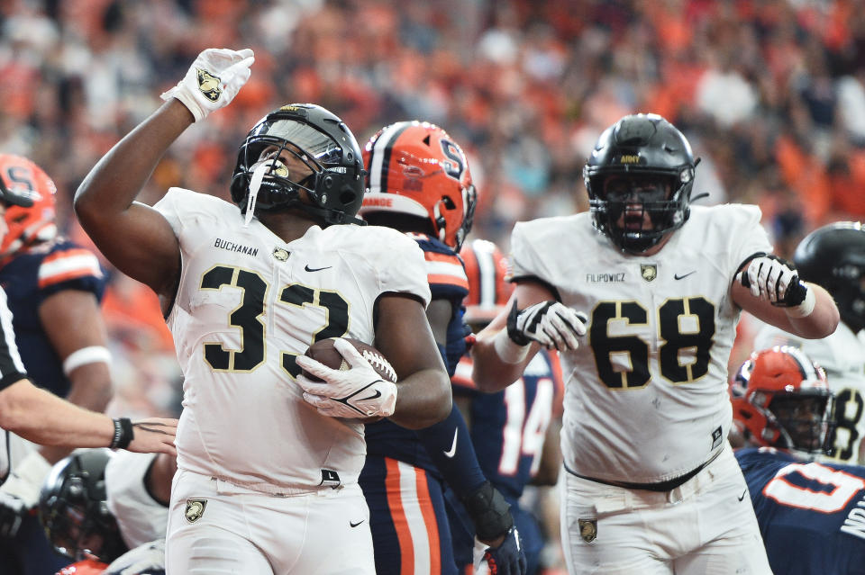 Army running back Jakobi Buchanan, left, celebrates after scoring during the first half of an NCAA college football game against Syracuse in Syracuse, N.Y., Saturday, Sept. 23, 2023. (AP Photo/Adrian Kraus)