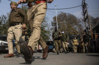 Indian police chase activists of Peoples Democratic party (PDP) protesting against India's new land laws that allows any Indian citizen to buy land in the disputed region in Srinagar, Indian controlled Kashmir, Thursday, Oct. 29, 2020. Until last year, Indians were not allowed to buy property in the region. But in August 2019, Prime Minister Narendra Modi’s government scrapped the disputed region’s special status, annulled its separate constitution, split the region into two federal territories. (AP Photo/Mukhtar Khan)