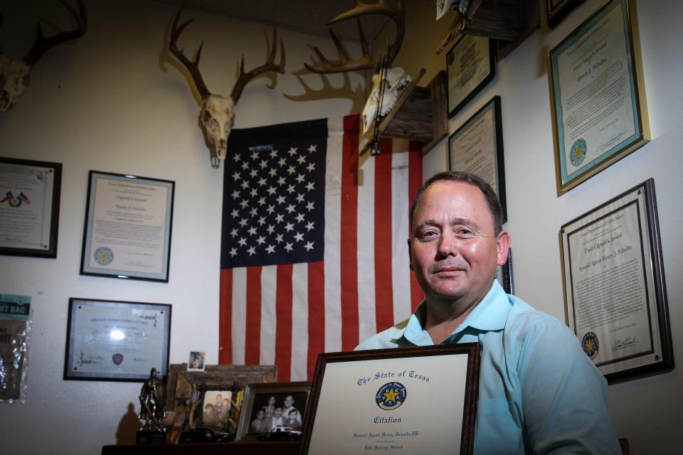 In his office, Special Agent Henry J. Schultz, with the Texas Department of Public Safety, holds a Life Saving Award he received from DPS for a criminal investigation that led to the location of a missing Corpus Christi minor who was in a life-threatening situation in July last year. Schultz was recently promoted and will join the Texas Ranger Division at the beginning of June.
