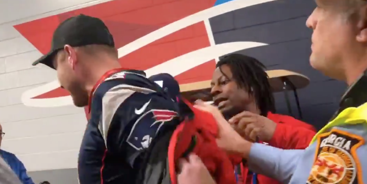 A man in a Tom Brady jersey allegedly tried to sneak into the Pats locker room by wearing a security coat. (Photo: Sheena Quick / Twitter)