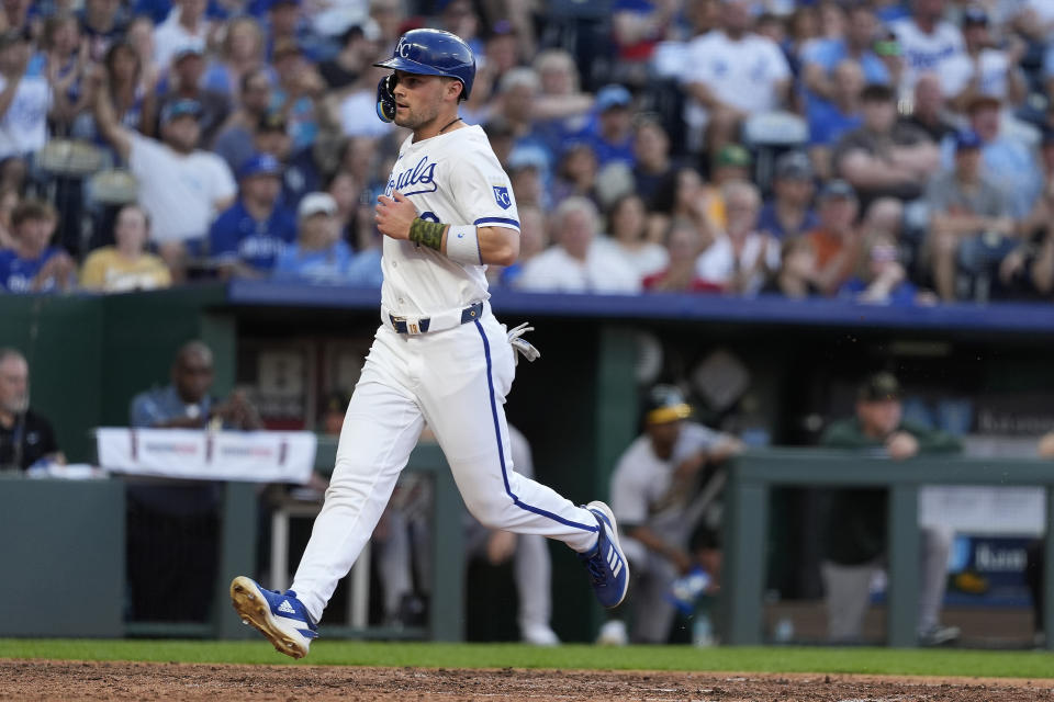 Kansas City Royals' Michael Massey runs home to score on a single by Nelson Velazquez during the sixth inning of a baseball gameagainst the Oakland Athletics Saturday, May 18, 2024, in Kansas City, Mo.(AP Photo/Charlie Riedel)
