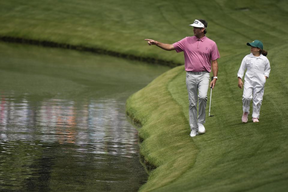 Bubba Watson walks with his daughter, Dakota on the fifth hole during the par-3 contest at the Masters golf tournament at Augusta National Golf Club Wednesday, April 10, 2024, in Augusta, GA. (AP Photo/Charlie Riedel)