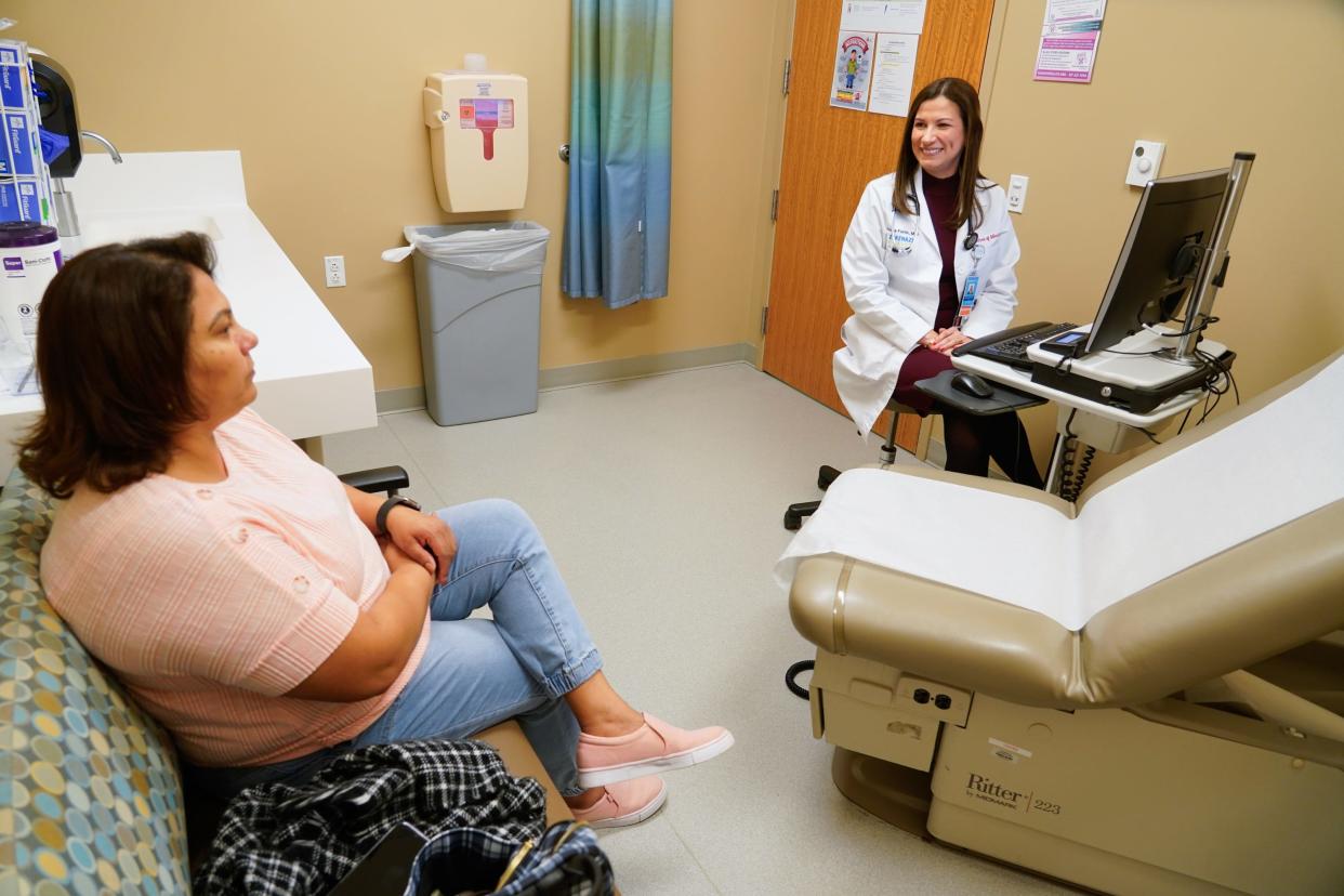 Saura Fortin Erazo, M.D. sees patient Mary Santos in Primary Care on Tuesday, Dec. 12, 2023, at Sidney & Lois Eskenazi Hospital in downtown Indianapolis. As an Eskenazi Health provider, Fortin Erazo also staffs the urgent care clinic.