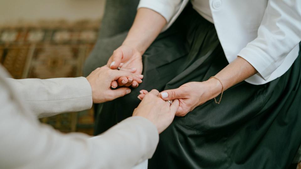 Two mature women hugging each other. Elegantly dressed. Woman psychologist practicing with patient women. Coach session between girlfriends.