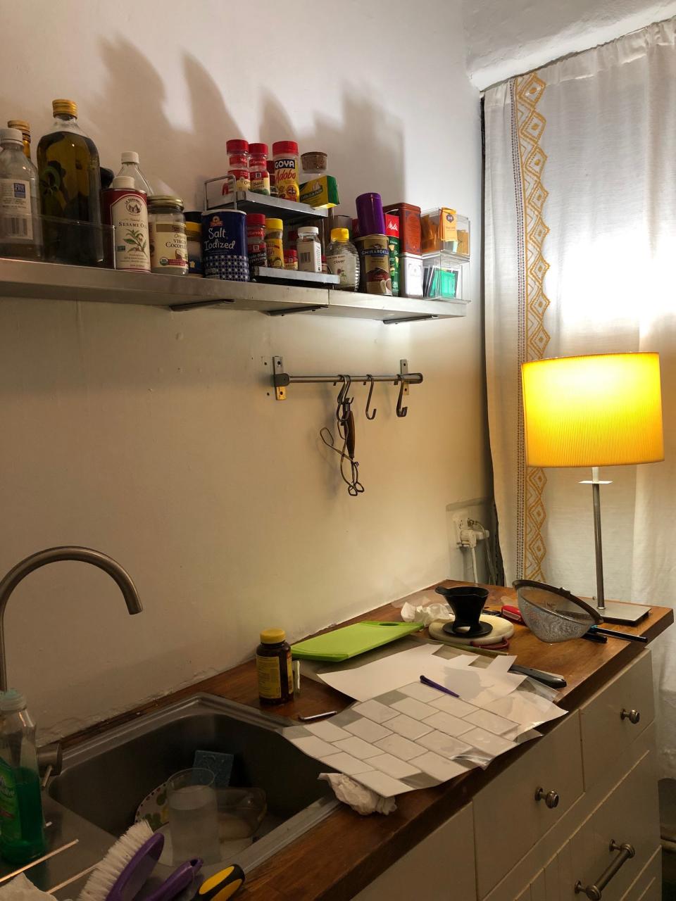 A kitchen counter against a white wall.