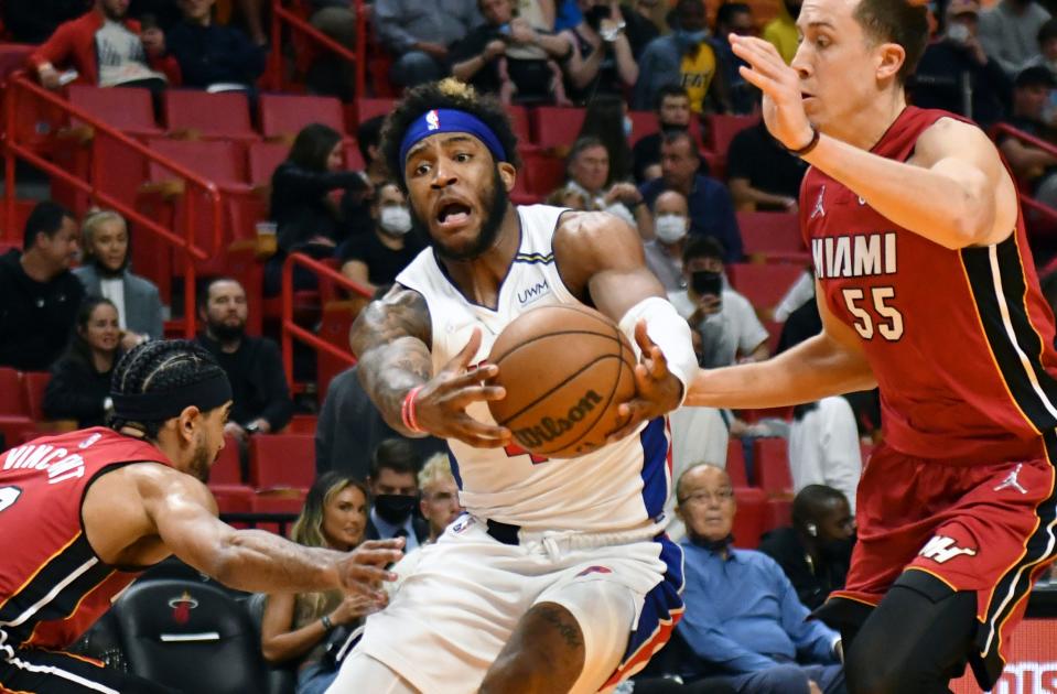 Miami Heat guard Gabe Vincent (2) tips the ball away from Detroit Pistons forward Saddiq Bey (41) as Heat guard Duncan Robinson (55) closes in during the first half on Thursday, Dec. 23, 2021, at FTX Arena in Miami.