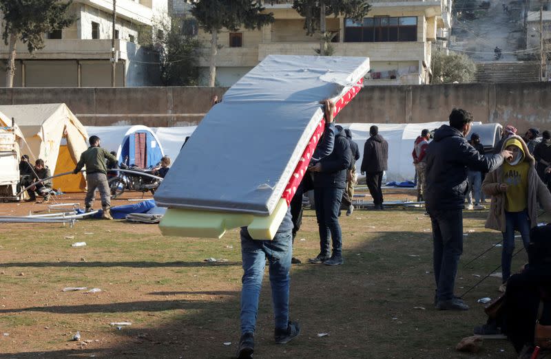 Displaced Syrians set up tents in a school yard in Harem