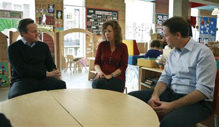 Britain's Prime Minister David Cameron (L) and deputy Prime Minister Nick Clegg (R) speak with parent Wendy Pearce during their visit to the Coin Street nursery in London March 18, 2014. REUTERS/Peter Macdiarmid/pool