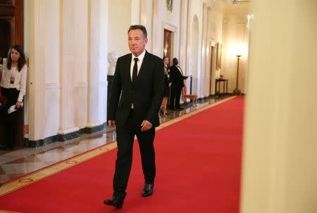 Musician Bruce Springsteen walks to his seat before a ceremony awarding the Presidential Medal of Freedom to various receipients in the East Room of the White House in Washington, U.S., November 22, 2016. REUTERS/Carlos Barria