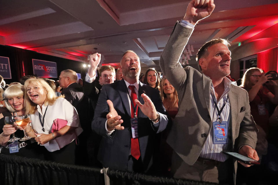 Attendees at an election watch party cheer as the watch televised election results, Tuesday, Nov. 6, 2018, in Naples, Fla. (AP Photo/Wilfredo Lee)