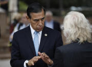 Former congressman Darrell Issa, left, speaks with a reporter after a news conference Thursday, Sept. 26, 2019, in El Cajon, Calif. Issa, a former congressman, announced he will attempt a return to Congress to replace fellow Republican and longtime-U.S. Rep. Duncan Hunter, who is running for re-election while under indictment on corruption charges. (AP Photo/Gregory Bull)