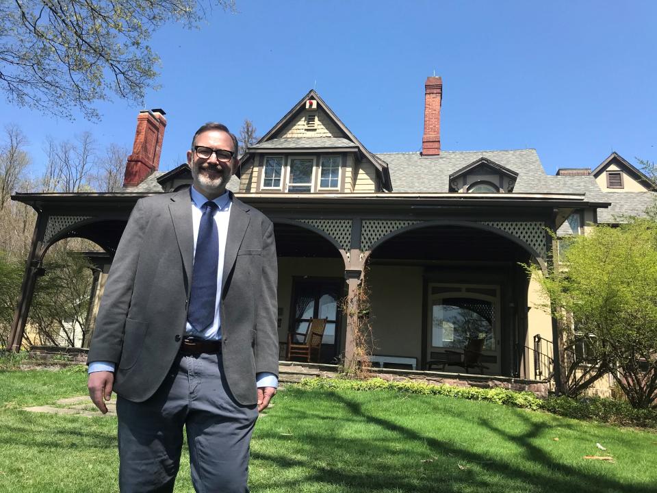 Joseph Lemak, director of the Center for Mark Twain Studies at Elmira College, stands in front of Quarry Farm, Twain's summer home in Elmira. The center will host a series of public lectures on Twain in May.