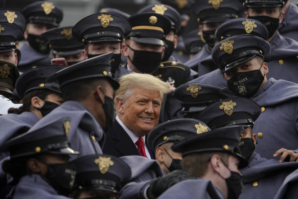 Surrounded by Army cadets, President Donald Trump watches the 121st Army-Navy Football Game in Michie Stadium at the United States Military Academy, Saturday, Dec. 12, 2020, in West Point, N.Y. (AP Photo/Andrew Harnik)