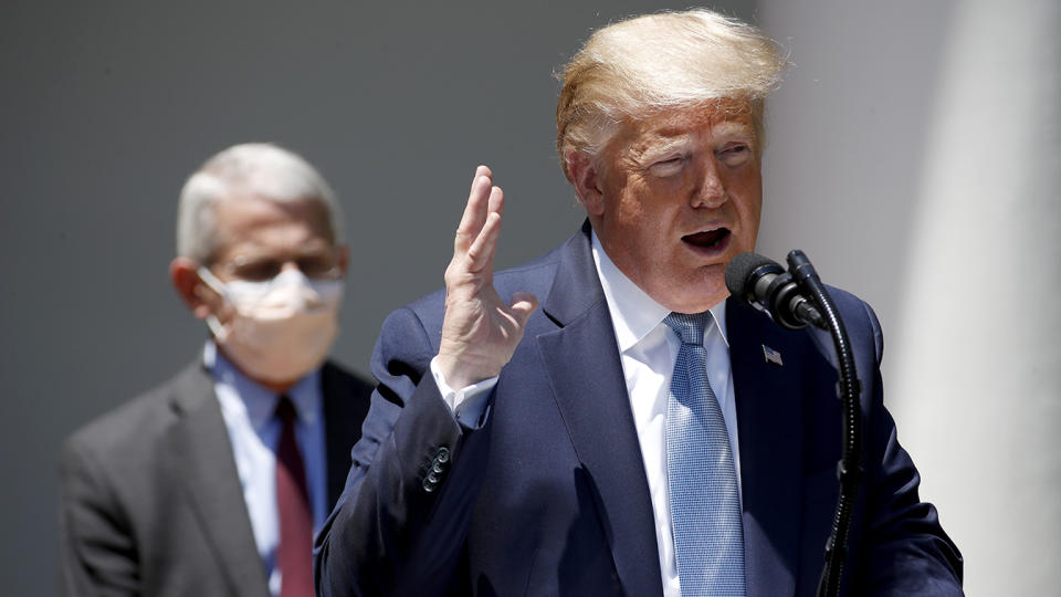 President Donald Trump speaks about the coronavirus in the Rose Garden of the White House, Friday, May 15, 2020, in Washington. Director of the National Institute of Allergy and Infectious Diseases Dr. Anthony Fauci listens at left. (Alex Brandon/AP)