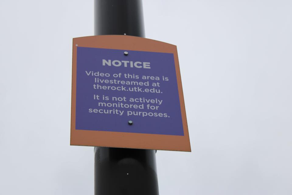 A sign attached to a lamppost near the Rock tells students the area is being livestreamed.