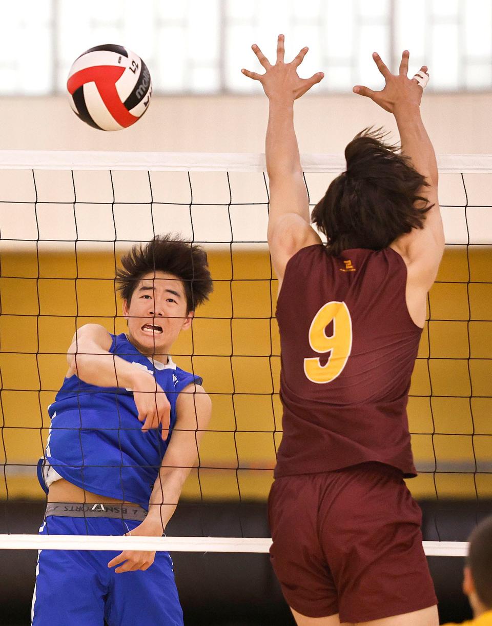 Deon Li of Braintree spikes the ball past Weymouth's Hugo DeOliveira on Thursday May 16, 2024