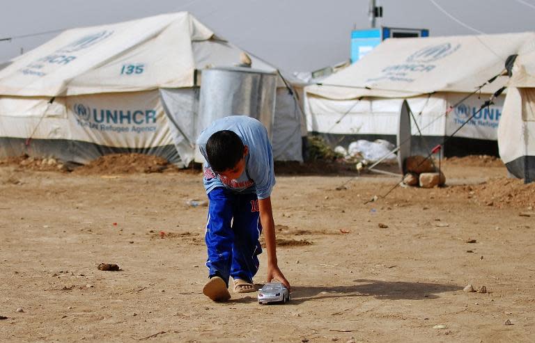 A displaced Iraqi boy -- who feld an offensive led by Islamic State militants -- plays at the Garmawa camp in Dohuk, on October 4, 2014