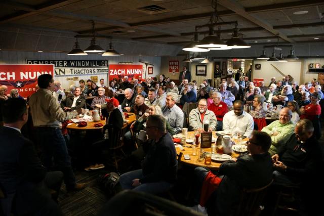 Members of the Westside Conservative Club listen to a debate among the three candidates running in the Republican primary to represent Iowa&#39;s 3rd Congressional District on Wednesday, April 27, 2022, at the Machine Shed in Urbandale, Iowa.