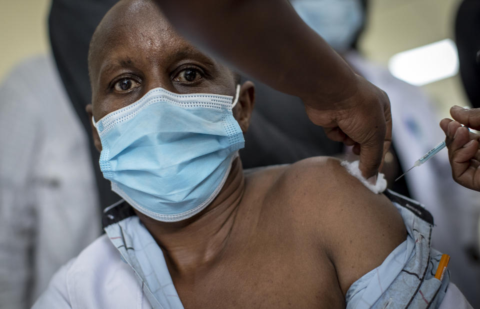 A member of hospital staff receives one of the country's first coronavirus vaccinations using AstraZeneca COVID-19 vaccine manufactured by the Serum Institute of India and provided through the global COVAX initiative, at Kenyatta National Hospital in Nairobi, Kenya Friday, March 5, 2021. Urgent calls for COVID-19 vaccine fairness rang through African countries on Friday as more welcomed or rolled out doses from the global COVAX initiative, with officials acutely aware their continent needs much more. (AP Photo/Ben Curtis)