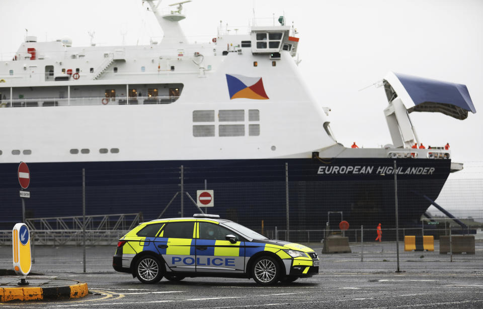 Police patrol the port of Larne, Northern Ireland, Tuesday, Feb. 2, 2021. Authorities in Northern Ireland have suspended checks on animal products and withdrawn workers from two ports after threats against border staff. (AP Photo/Peter Morrison)