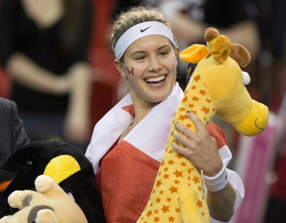 Eugenie Bouchard, of Canada, holds a stuffed animal she received from a fan as she celebrates her win against Jana Cepelova, of Slovakia, during the third match at the Fed Cup tennis tournament at Laval University in Quebec City on Sunday, April 20, 2014. Bouchard won the match. (AP Photo/The Canadian Press, Jacques Boissinot)