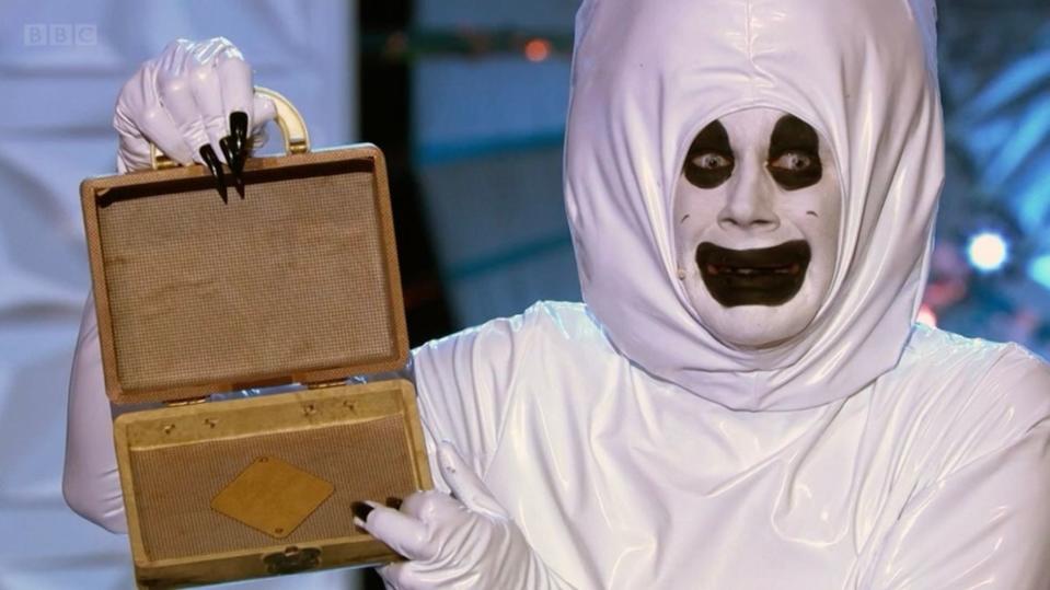 Jimbo in a "ghost sperm" outfit holding up a small, empty jewelry box