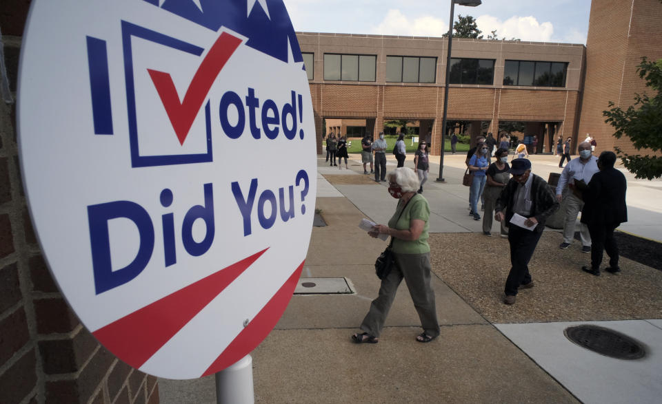 Voters line up outside to cast ballots in the general election at the Henrico County general registrar's office in Henrico County, Va., Friday, Sept. 18, 2020. (Bob Brown/Richmond Times-Dispatch via AP)