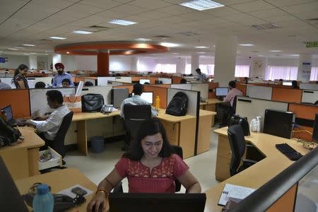 Employees work at the Indian headquarters of iGate in Bangalore February 4, 2013. REUTERS/Stringer/Files