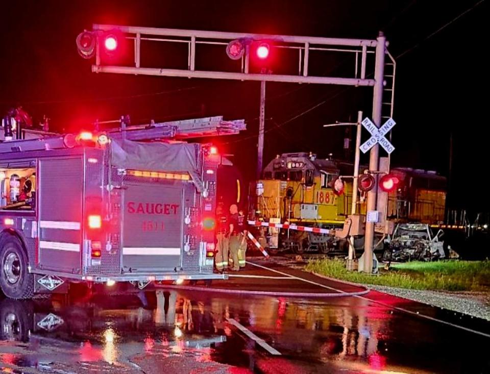 The charred wreckage of a pickup truck, far right, are shown next to a Union Pacific train after a crash at a railroad crossing early Saturday morning on Mississippi Avenue in Sauget.