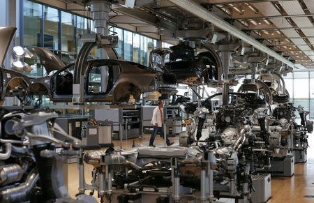 FILE PHOTO - A workers walks in the factory inside the Glaeserne Manufaktur (transparent factory) where Germany's car maker Volkswagen AG assemble the luxury model Phaeton, in Dresden May 14, 2013. REUTERS/Fabrizio Bensch/File Photo