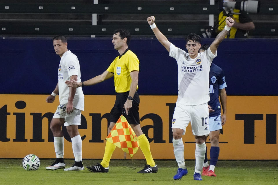 Los Angeles Galaxy's Cristian Pavon (10) celebrates after a 1-0 win over the Vancouver Whitecaps in an MLS soccer match, Sunday, Oct. 18, 2020, in Carson, Calif. (AP Photo/Marcio Jose Sanchez)
