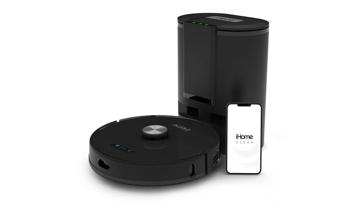 Black iHome robo vac with iPhone nearby to show that it can be controlled by an app