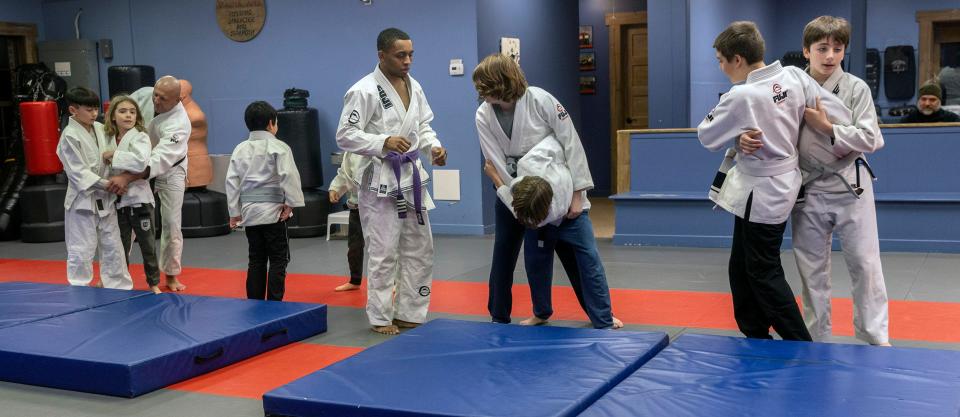 A class of 10- to 13-year-olds practice hip throws at Fair Haven Martial Arts. Wednesday, Feb. 1, 2023