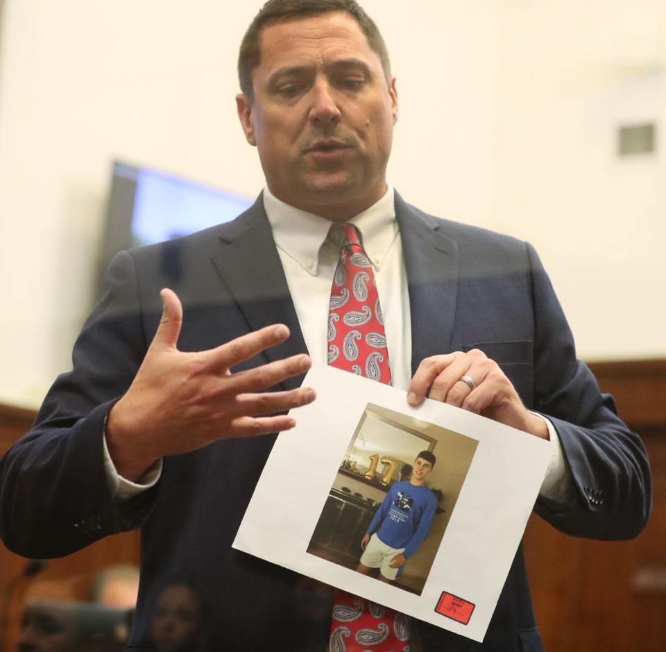 Summit County Assistant Prosecutor Matt Kuhn holds a photo of Ethan Liming as he gives his closing argument in trial of DeShawn and Tyler Stafford in the death of Ethan Liming in Summit County Common Pleas Judge Tammy O'Brien's courtroom.