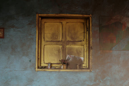 A window of a house is covered with ash after the eruption of the Fuego volcano at San Miguel Los Lotes in Escuintla, Guatemala, June 8, 2018. REUTERS/Carlos Jasso