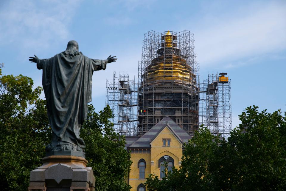 Workers gild the Golden Dome at the University of Notre Dame on Aug. 11.