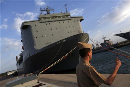 A U.S. navy personnel gestures in front of the U.S. MV Cape Ray ship docked at the naval airbase in Rota, near Cadiz, southern Spain April 10, 2014. REUTERS/Marcelo del Pozo