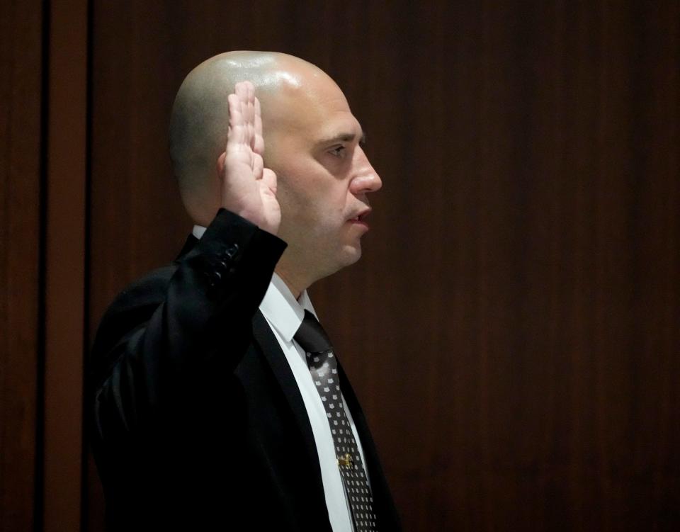 Waukesha Detective Jay Carpenter is sworn is before he testifies during the Darrell Brooks trial in Waukesha County Circuit Court in Waukesha, Wis., on Tuesday, Oct. 18, 2022. Brooks, who is representing himself during the trial, is charged with driving into a Waukesha Christmas Parade last year, killing six people and injuring dozens more.