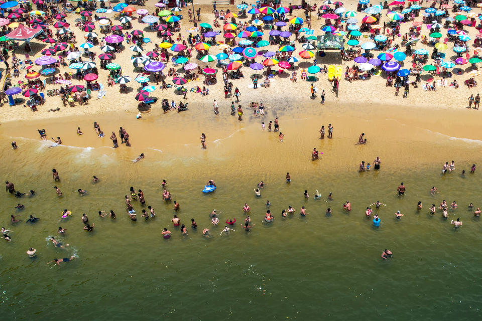 Dangerous Heat Wave Hits Rio De Janeiro aerial beach swimmers umbrellas colorful (Buda Mendes / Getty Images)