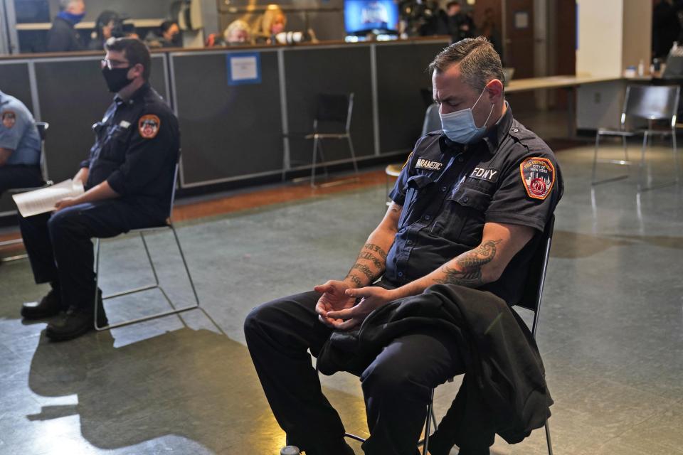 New York City firefighter emergency medical services personnel wait for 15 minutes after being vaccinated against COVID-19 at the FDNY Fire Academy in New York, Wednesday, Dec. 23, 2020. (AP Photo/Seth Wenig)