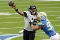 Jacksonville Jaguars quarterback Gardner Minshew, left, throws under pressure from Los Angeles Chargers defensive end Joey Bosa during the first half of an NFL football game Sunday, Oct. 25, 2020, in Inglewood, Calif. (AP Photo/Alex Gallardo )