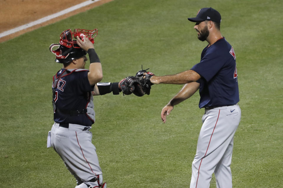 Boston Red Sox relief pitcher Brandon Workman, right, and catcher Christian Vazquez celebrate the team's 4-2 win over the New York Mets in a baseball game Thursday, July 30, 2020, in New York. (AP Photo/Seth Wenig)