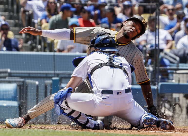 Los Angeles, CA, Sunday, July 3, 2022 - San Diego Padres right fielder Jose Azocar (28) is tagged out by Los Angeles Dodgers catcher Austin Barnes (15) on a fielders choice grounder hit by Manny Machado in the third inning at Dodger Stadium. (Robert Gauthier/Los Angeles Times)