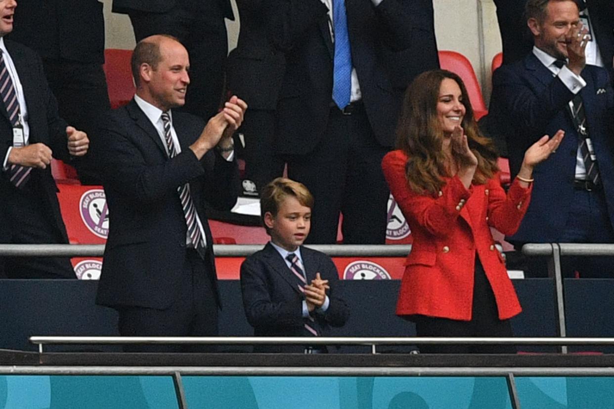 Prince William, Duke of Cambridge, Prince George of Cambridge, and Catherine, Duchess of Cambridge, celebrate the first goal   (POOL/AFP via Getty Images)