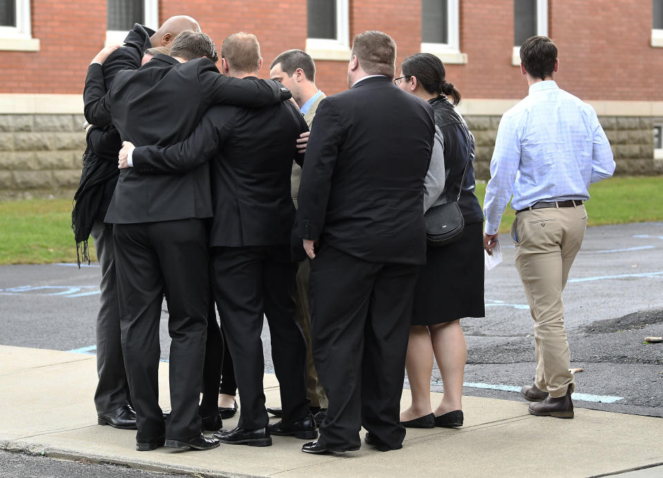 Friends and family arrive for a funeral Mass for eight of the 20 people killed in last Saturday's fatal limousine crash in Schoharie, N.Y., at St. Stanislaus Roman Catholic Church in Amsterdam, N.Y., Saturday, Oct. 13, 2018. (AP Photo/Hans Pennink)