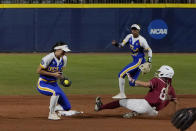 Alabama's KB Sides (8) steals second base as UCLA's Briana Perez, left, takes the throw during the first inning of an NCAA Women's College World Series softball game Friday, June 4, 2021, in Oklahoma City. (AP Photo/Sue Ogrocki)