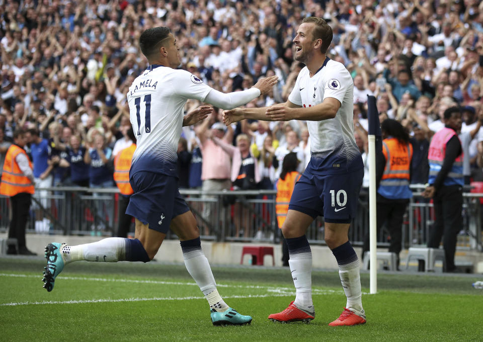 Tottenham Hotspur's Harry Kane, right, celebrates scoring his side's third goal of the game against Fulham, with team-mate Erik Lamela, during their English Premier League soccer match at Wembley Stadium in London, Saturday Aug. 18, 2018. (Nick Potts/PA via AP)