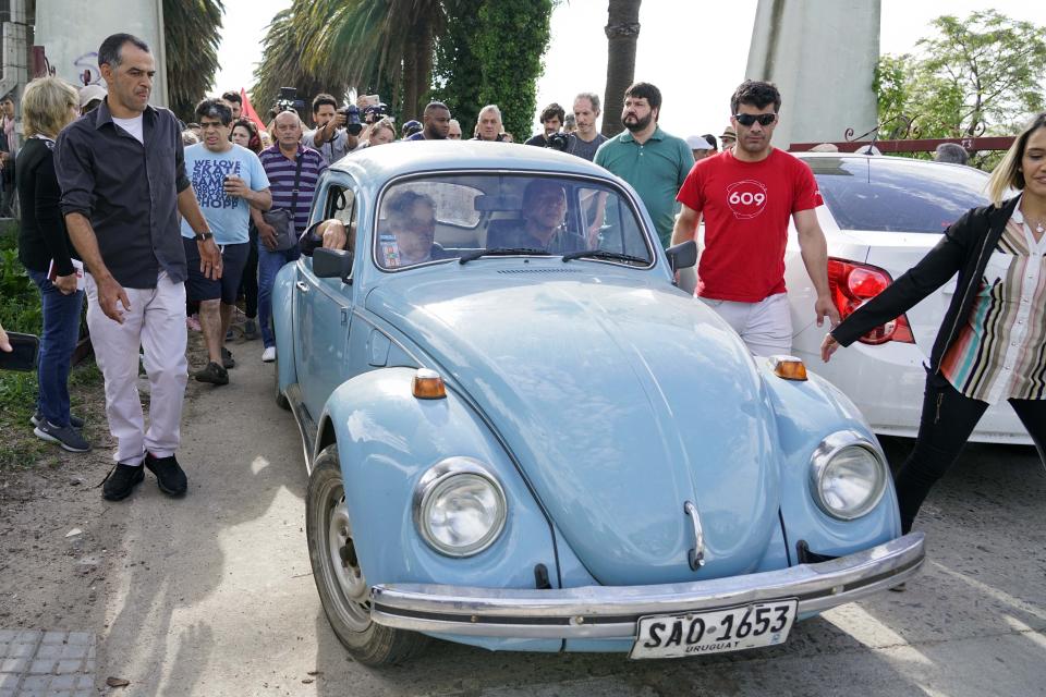 Former President Jose Mujica, of the ruling Broad Front, front seat left, arrives to vote in Montevideo, Uruguay, Sunday, Oct. 27, 2019. Fifteen years of leftist rule hangs in the balance as Uruguay faces a tight presidential election that is likely to head to a runoff vote. (AP Photo/Matilde Campodonico)