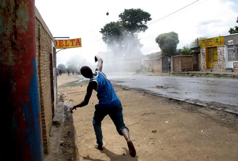 A protester throws stones at police during street battle in Mugasa district of Bujumbura, Burundi, on May 4, 2015